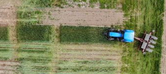 A tractor about to enter a crop field
