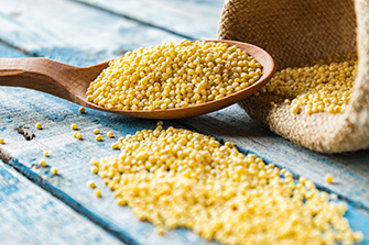 A wooden spoon with millet