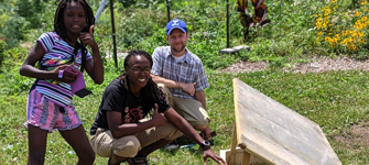 Three people practicing urban agriculture
